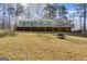 A welcoming home boasts a large deck perfect for outdoor living with a spacious yard and mature trees at 4864 Yeagar Rd, Douglasville, GA 30135