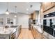 Well-lit kitchen features stainless steel appliances, granite countertops, and wood flooring at 4864 Yeagar Rd, Douglasville, GA 30135