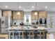 Modern kitchen boasts a large island with seating, stainless steel appliances, and wood flooring at 4864 Yeagar Rd, Douglasville, GA 30135