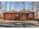 Functional outbuilding with double doors and a window offers storage and potential for various uses at 4864 Yeagar Rd, Douglasville, GA 30135