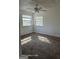 Sun-filled bedroom features neutral carpet, ceiling fan, and two windows, creating a bright and airy feel at 11187 Shannon Cir, Hampton, GA 30228