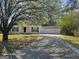 Charming one-story home with a large front yard and blooming tree at 11187 Shannon Cir, Hampton, GA 30228