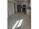 Bright kitchen featuring stainless steel appliances, white cabinetry, and tile flooring at 11187 Shannon Cir, Hampton, GA 30228