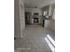 Bright kitchen with stainless steel appliances, white cabinetry, and tile flooring at 11187 Shannon Cir, Hampton, GA 30228