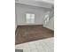 Inviting living room, blending carpet and tile floors, plus stairs to the upper level, promoting seamless transitions at 11187 Shannon Cir, Hampton, GA 30228