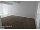 Open living space with carpeted floors, white walls, and access to the outdoors at 11187 Shannon Cir, Hampton, GA 30228