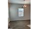 Bright dining area with modern chandelier, wood-look flooring, and natural light from the window at 229 Ivey Ter # 37, Temple, GA 30179