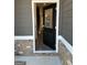 Welcoming front entrance featuring a stylish black door with glass inserts and decorative brick accents at 229 Ivey Ter # 37, Temple, GA 30179