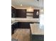 Stylish kitchen with granite countertops, dark wood cabinets, stainless appliances, and wood-look flooring at 229 Ivey Ter # 37, Temple, GA 30179