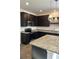 Modern kitchen featuring granite countertops, dark cabinetry, stainless steel appliances, and pendant lighting at 229 Ivey Ter # 37, Temple, GA 30179