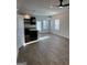 Open concept living room and kitchen area with modern lighting, wood floors and many windows at 229 Ivey Ter # 37, Temple, GA 30179