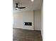 Bright living room with wood-look floors, modern ceiling fan, recessed lighting, and a sleek fireplace at 229 Ivey Ter # 37, Temple, GA 30179