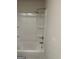 Shower/tub combo features a white surround, rainfall shower head, and built-in shelving at 229 Ivey Ter # 37, Temple, GA 30179