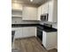 Modern kitchen with white cabinets, stainless steel appliances and sleek countertops at 231 Ivey Ter # 38, Temple, GA 30179