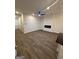 Expansive living area featuring recessed lighting, ceiling fan, modern fireplace and luxury vinyl flooring at 231 Ivey Ter # 38, Temple, GA 30179