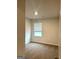 Bright bedroom featuring neutral walls, plush carpeting, and a window with natural light at 233 Ivey Ter # 39, Temple, GA 30179