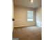 Neutral bedroom with window, carpet, and neutral walls at 233 Ivey Ter # 39, Temple, GA 30179