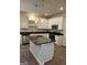 Bright kitchen boasts an island, modern stainless appliances, gray countertops, and white cabinetry at 233 Ivey Ter # 39, Temple, GA 30179