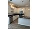 Bright kitchen boasts an island, modern stainless appliances, gray countertops, and white cabinetry at 233 Ivey Ter # 39, Temple, GA 30179