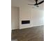 Living room featuring luxury vinyl floors, modern fan, and linear fireplace at 233 Ivey Ter # 39, Temple, GA 30179