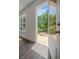 A sunlit balcony overlooking lush greenery, accessible from a pristine interior with wood flooring at 2443 Sycamore Nw Rd, Atlanta, GA 30318