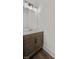 Modern half bathroom features a vanity with dark wood cabinets and brass fixtures at 2443 Sycamore Nw Rd, Atlanta, GA 30318