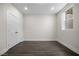 Bright bedroom features a window, double door closet, and sleek wood floors at 2443 Sycamore Nw Rd, Atlanta, GA 30318