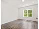 Bedroom with hardwood floors, white walls and a large window providing natural light at 2443 Sycamore Nw Rd, Atlanta, GA 30318