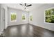 Bright bedroom features hardwood floors, ceiling fan, and three windows at 2443 Sycamore Nw Rd, Atlanta, GA 30318