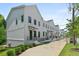 Row of modern townhomes featuring clean white exteriors and well-maintained landscaping at 2443 Sycamore Nw Rd, Atlanta, GA 30318