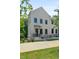 Charming two-story home with a white brick facade and a beautifully landscaped yard at 2443 Sycamore Nw Rd, Atlanta, GA 30318