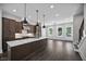 Spacious kitchen with a large center island, stainless appliances, and modern lighting fixtures at 2443 Sycamore Nw Rd, Atlanta, GA 30318