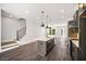 Open concept kitchen with a center island, modern appliances, and hardwood floors at 2443 Sycamore Nw Rd, Atlanta, GA 30318