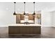 Spacious kitchen featuring a large island, pendant lighting, and sleek appliances at 2443 Sycamore Nw Rd, Atlanta, GA 30318
