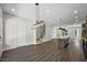 Open living space with hardwood floors, modern lighting, and staircase at 2443 Sycamore Nw Rd, Atlanta, GA 30318