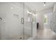 Spacious shower with glass door, white subway tile, bench, and overhead lighting at 2443 Sycamore Nw Rd, Atlanta, GA 30318