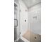 Detailed view of the glass shower that features white tile and a shower niche at 2443 Sycamore Nw Rd, Atlanta, GA 30318