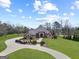 Wide angle aerial view of a brick home, circular driveway, and extensive lawn at 1198 Elliot Rd, Mcdonough, GA 30252
