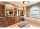Spacious bathroom with granite counters, wooden cabinets, soaking tub and tiled floors at 1198 Elliot Rd, Mcdonough, GA 30252