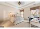 Sun-filled primary bedroom features neutral walls, tray ceilings and a decorative ceiling fan at 1198 Elliot Rd, Mcdonough, GA 30252