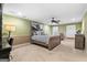 Spacious bedroom with a ceiling fan, a cozy bed and a decorative plane propeller print at 1198 Elliot Rd, Mcdonough, GA 30252