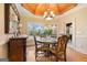 Dining room boasts custom cabinetry, coffered ceiling, and view of the backyard at 1198 Elliot Rd, Mcdonough, GA 30252