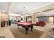 Large game room featuring a billiards table, adjacent dining area, and theater room with comfortable leather chairs at 1198 Elliot Rd, Mcdonough, GA 30252