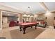 Open game room with a billiards table, comfortable seating, and movie screen for entertaining guests at 1198 Elliot Rd, Mcdonough, GA 30252