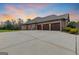 Side view of house featuring 3-car garage with brick facade and large driveway at 1198 Elliot Rd, Mcdonough, GA 30252