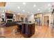 Open kitchen design with granite island, hardwood floors, and adjacent living space at 1198 Elliot Rd, Mcdonough, GA 30252