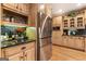 Kitchen features a stainless steel refrigerator, custom cabinets and hardwood floors at 1198 Elliot Rd, Mcdonough, GA 30252