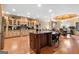 Open kitchen with granite island, custom cabinets, and modern appliances, with adjacent dining area at 1198 Elliot Rd, Mcdonough, GA 30252