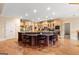 Large kitchen island with seating and granite countertop amidst custom wood cabinetry at 1198 Elliot Rd, Mcdonough, GA 30252
