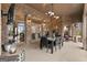Covered patio with brick columns, ceiling fans, dining table and outdoor furniture at 1198 Elliot Rd, Mcdonough, GA 30252